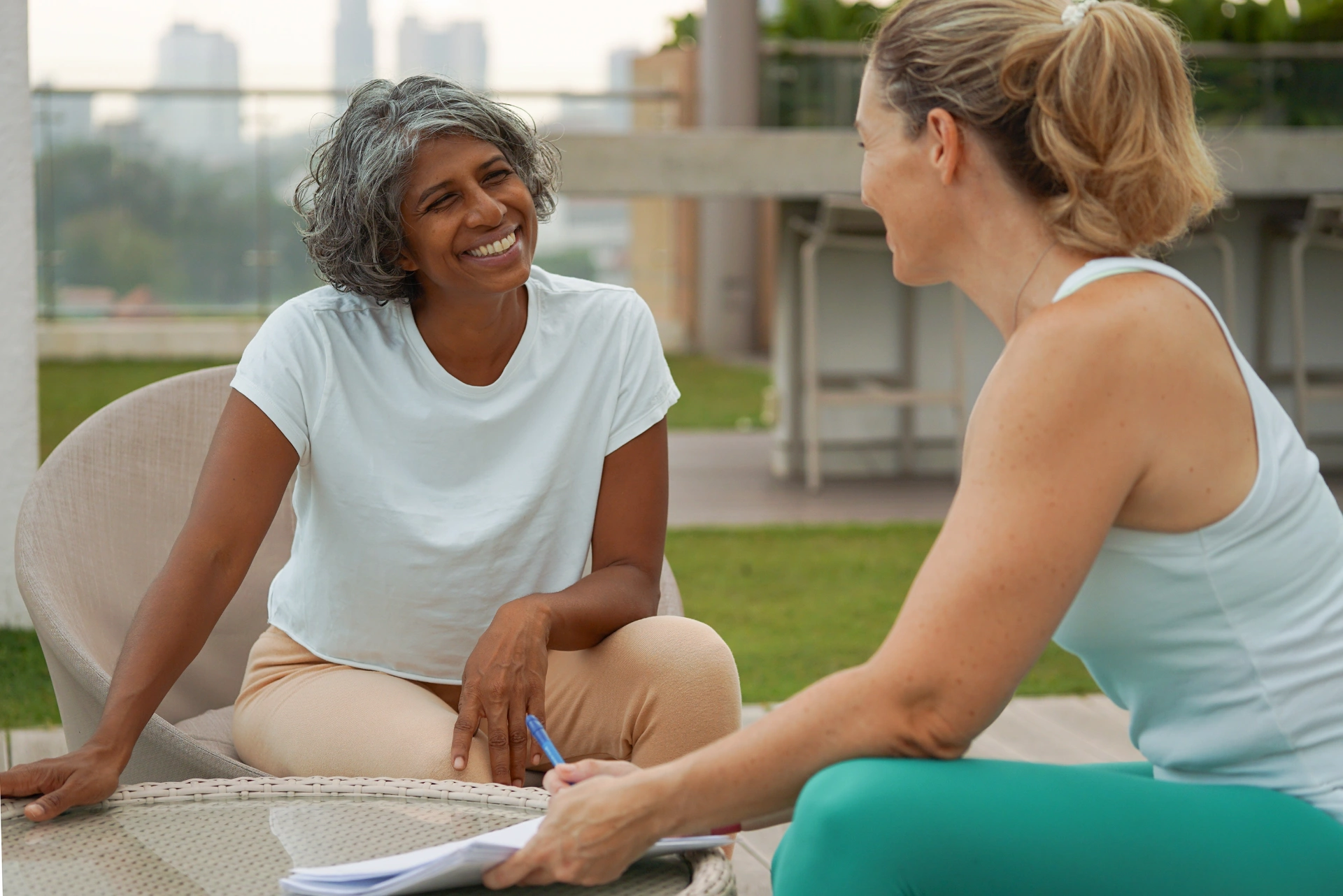 Two women having a warm coaching conversation outdoors